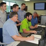 Naval Research Enterprise Internship Program (NREIP) interns describe the Capture the Flag (CTF) cybersecurity challenge to Naval Surface Warfare Center Panama City Division (NSWC PCD) employees during the CTF event at Gulf Coast State College on July 15, 2016. Pictured from left to right: NREIP intern Trevor Phillips, Mark Bates, NREIP intern Daniel Jermyn, Josh Westmoreland, David Cole and Tim McCabe.  U.S. Navy Photo by Katherine Mapp (Released) 160715-N-PD526-007