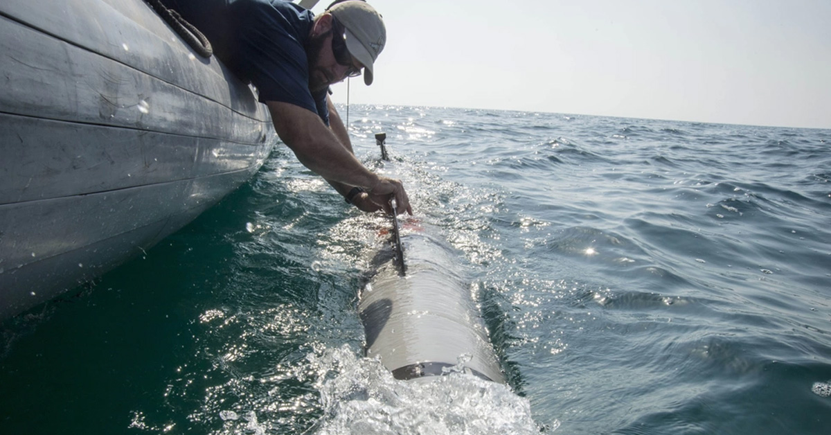 An operator handles a MK 18 MOD 2 UUV. Photo: DVIDS Operator and UUV. An operator recovers a MK 18 MOD 2 unmanned underwater vessel.